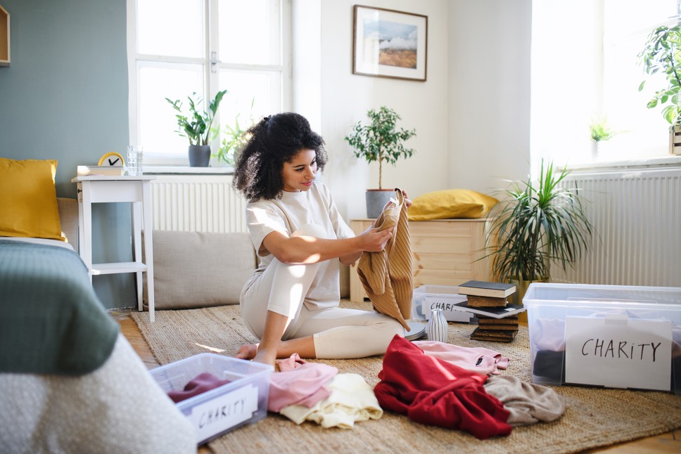 Woman sorting clothes into donation boxes